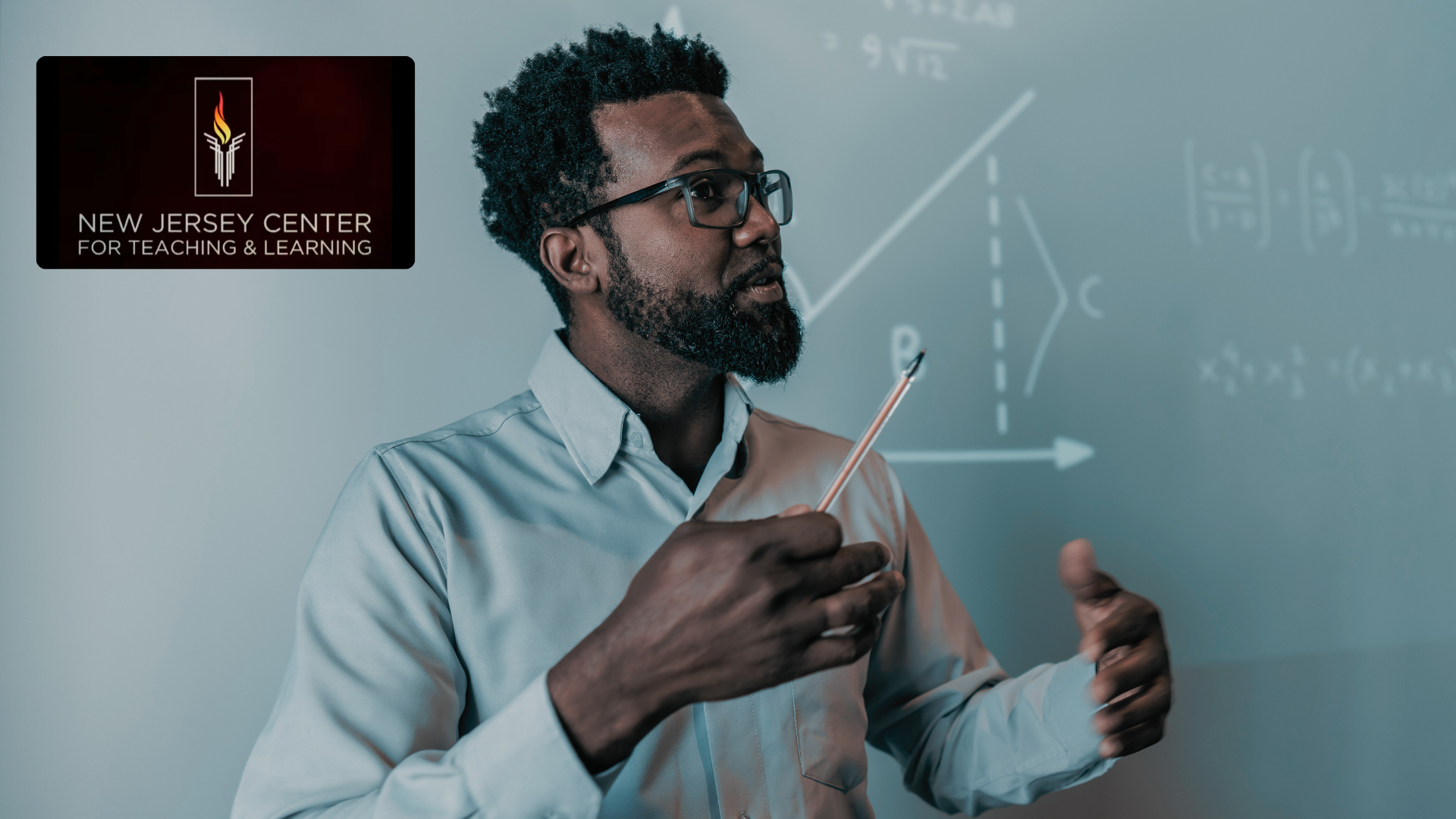 Math instructor explaining a concept while pointing to equations on a board