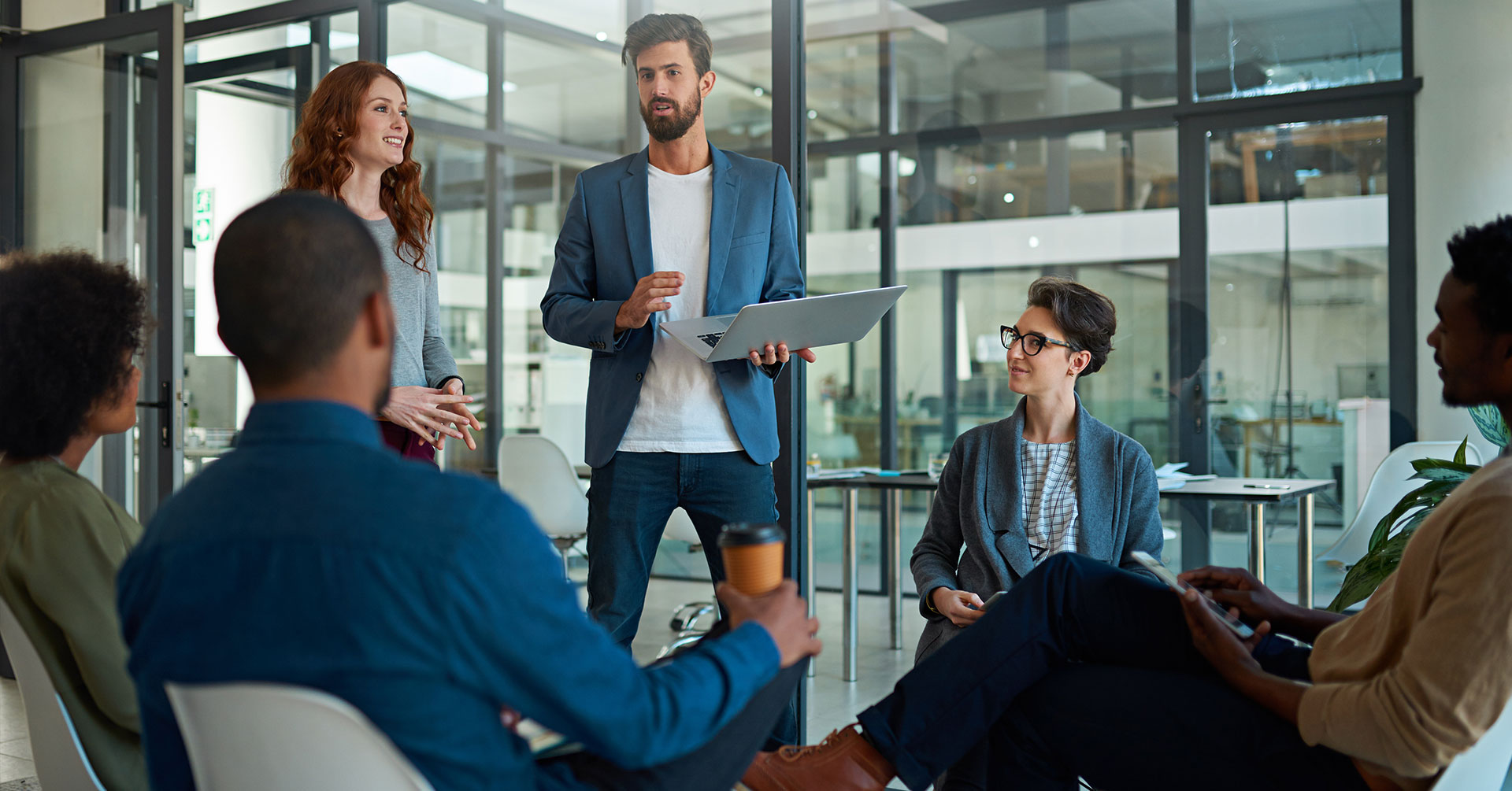 coworkers sitting in a circle at a meeting